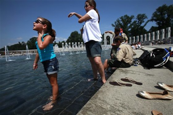 Marya Luiza Albano, 6, of Rio de Janeiro, Brazil, cools off at the World War II Memorial on the National Mall as temperatures rise above 100 degrees in Washington on Saturday.